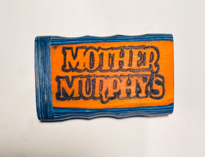 Orange-and-blue wooden dugout with distressed black “Mother Murphy’s” lettering