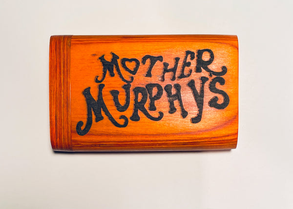 Orange wooden dugout with bold black “Mother Murphy’s” lettering