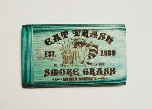 Teal wooden dugout with distressed black lettering on one side