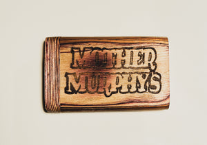 Wooden dugout with dark “MOTHER MURPHY’S” lettering on honey-brown wood
