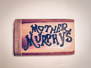 Wooden dugout with blue “MOTHER MURPHY’S” lettering on light wood