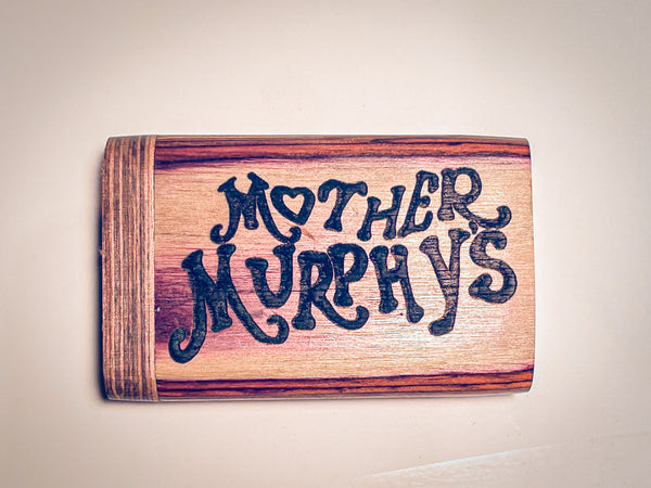 Wooden dugout with blue “MOTHER MURPHY’S” lettering on light wood