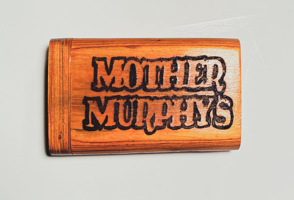 Wooden dugout with dark “MOTHER MURPHY’S” lettering on orange wood
