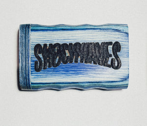 Wooden dugout with blue stripes and bold dark “SIBOOMTATS” lettering