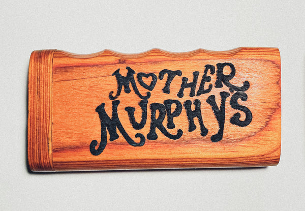 Orange wooden smoking dugout with black decorative lettering