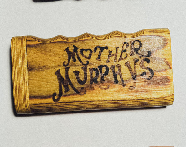 Wooden dugout with dark “Mother Murphy’s” lettering on honey-brown wood