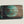 Load image into Gallery viewer, Wooden dugout with teal circle portrait logo on dark wood
