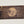 Load image into Gallery viewer, Wooden dugout with round face logo engraved on dark stained wood
